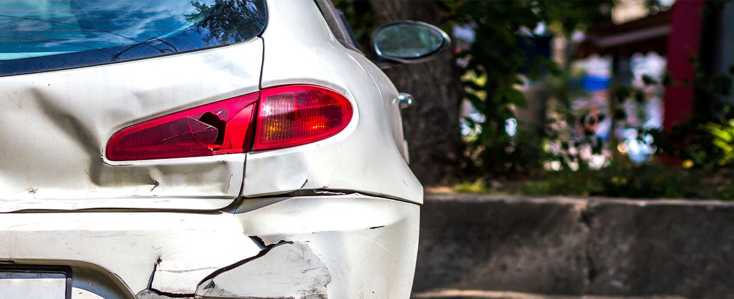 white car with rear end damage