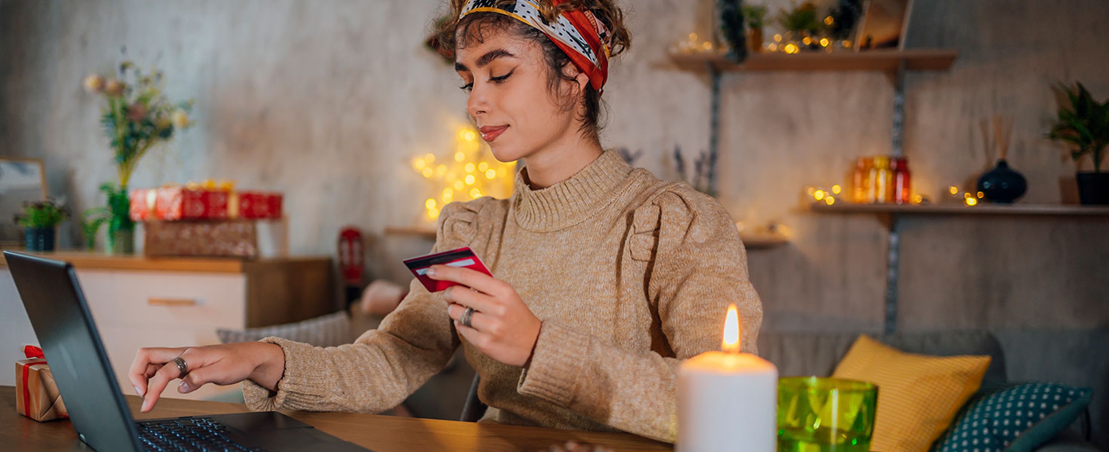 Young woman using lap top for Christmas online shopping. Photo by LordHenriVoton
