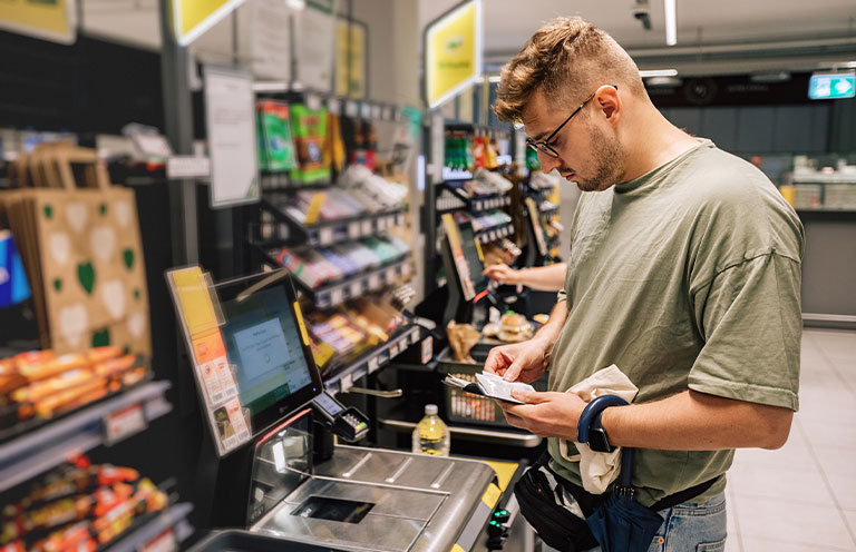 man using card to pay in store