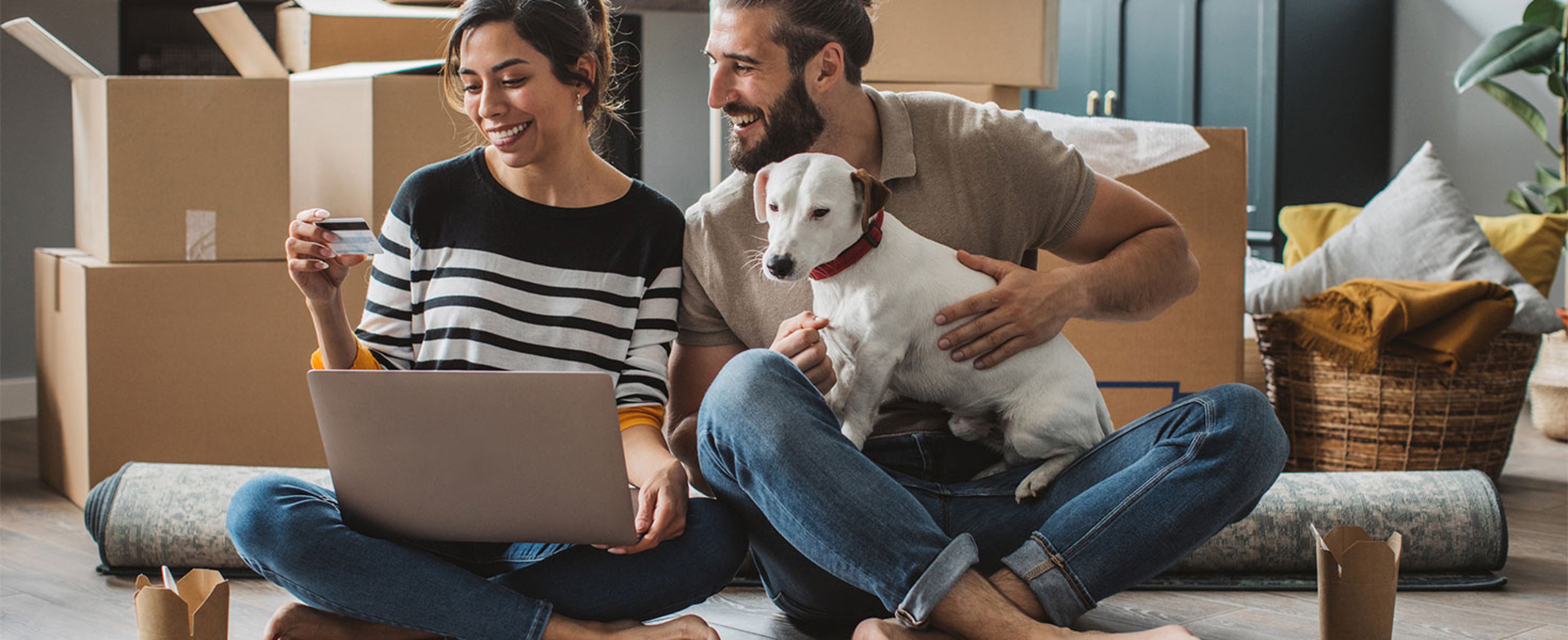 couple looking at credit card and laptop