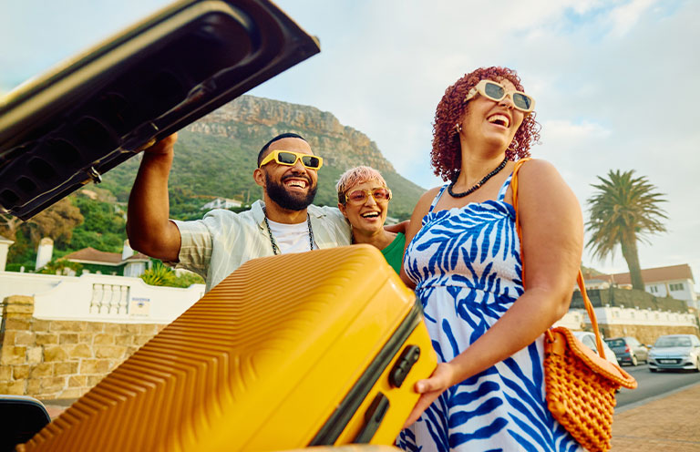 family unpacking car on vacation