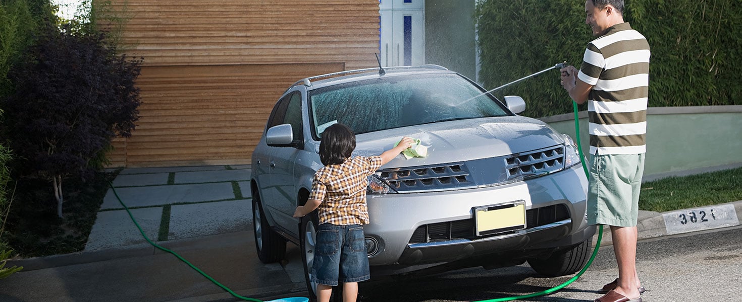 Father and son washing car. Image Source/iStock.com