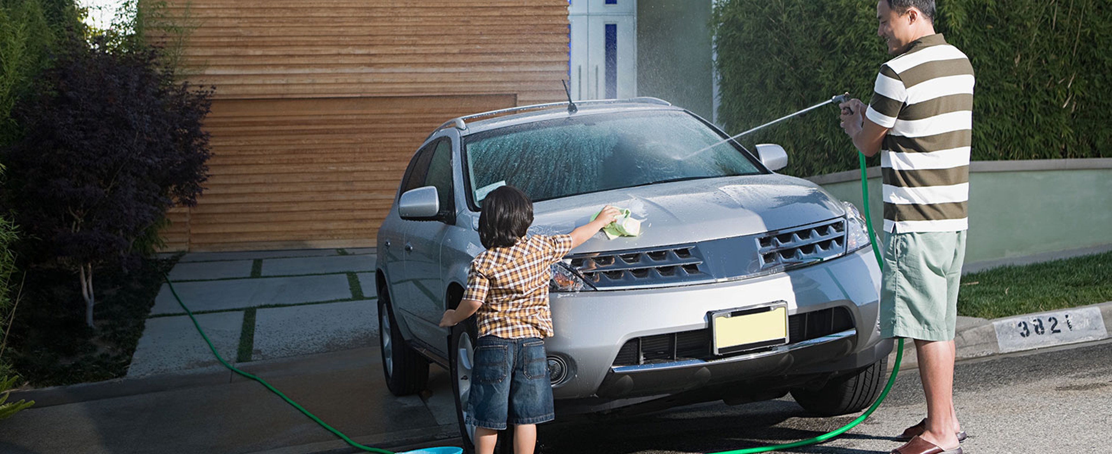 Father and son washing car. Image Source/iStock.com