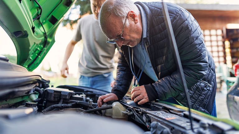 Grandfather and a teenage grandson kids are examining car engine. Shot with Canon R5 Credit: Imgorthand/istock.com