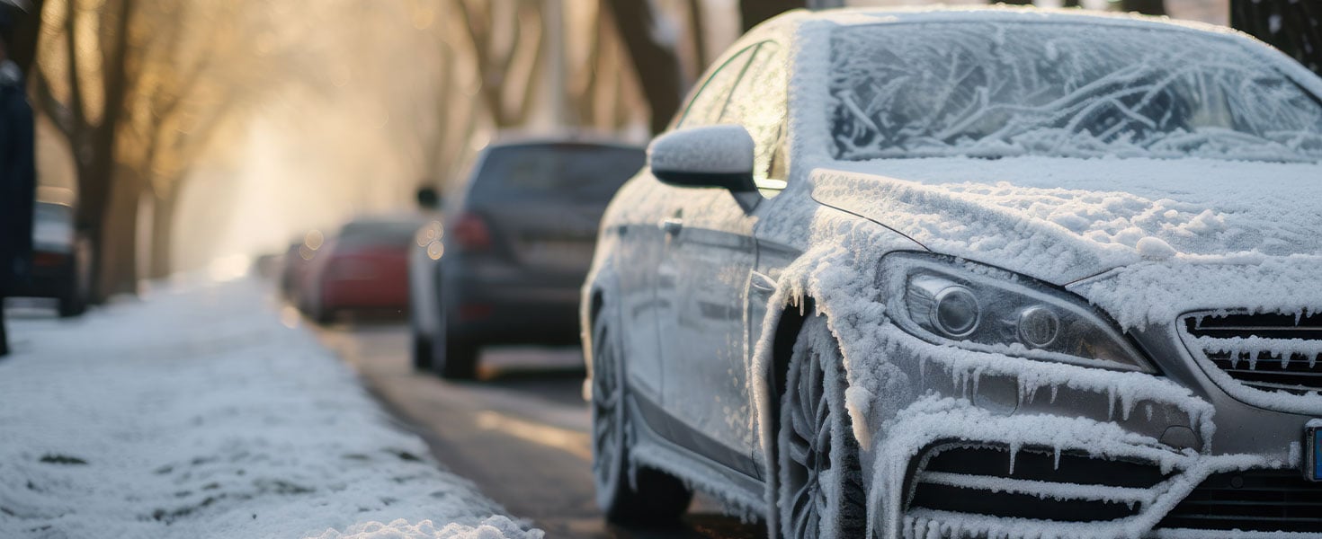 car parked on roadside covered in snow