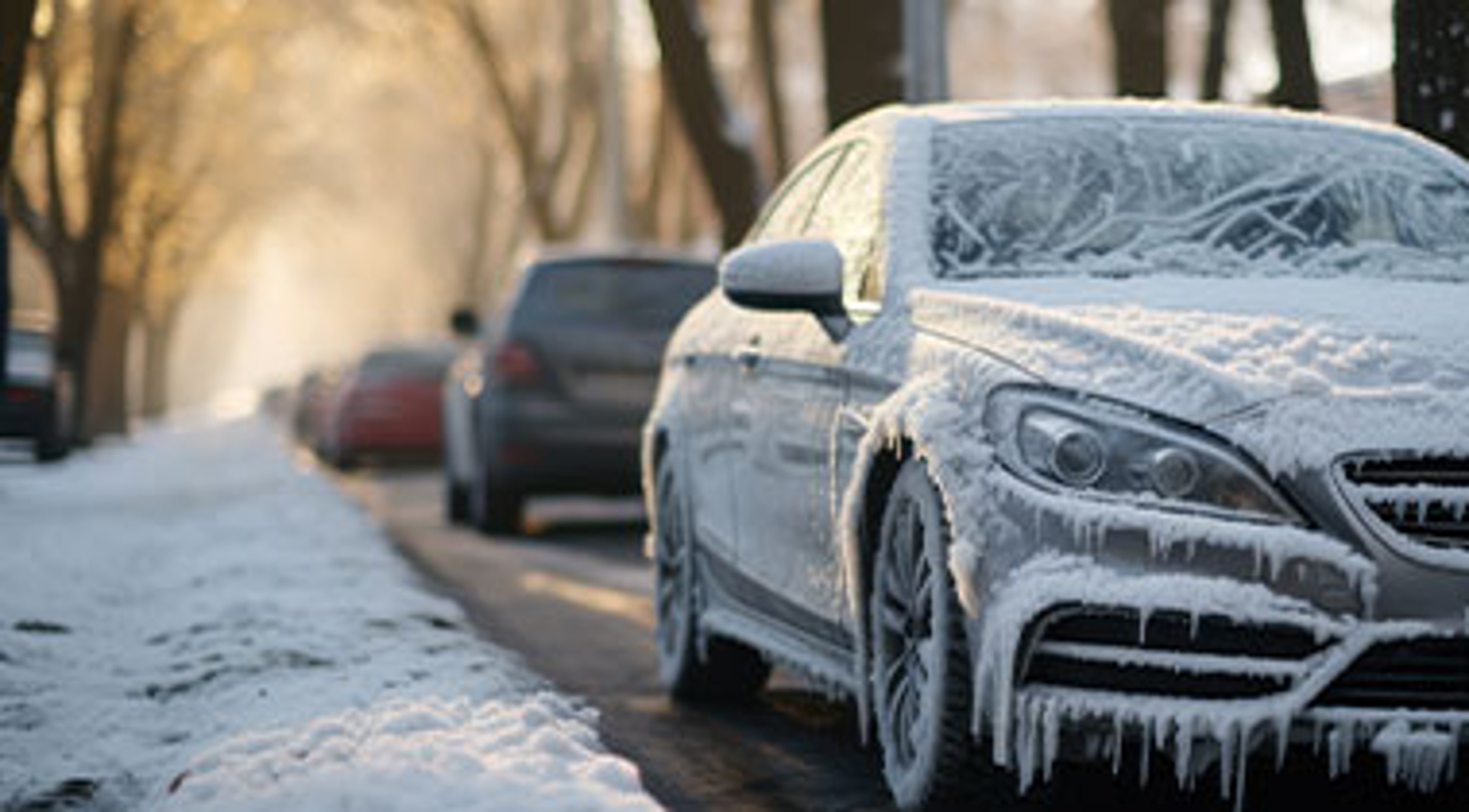 car parked on roadside covered in snow