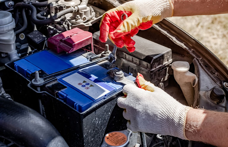 man installing car battery