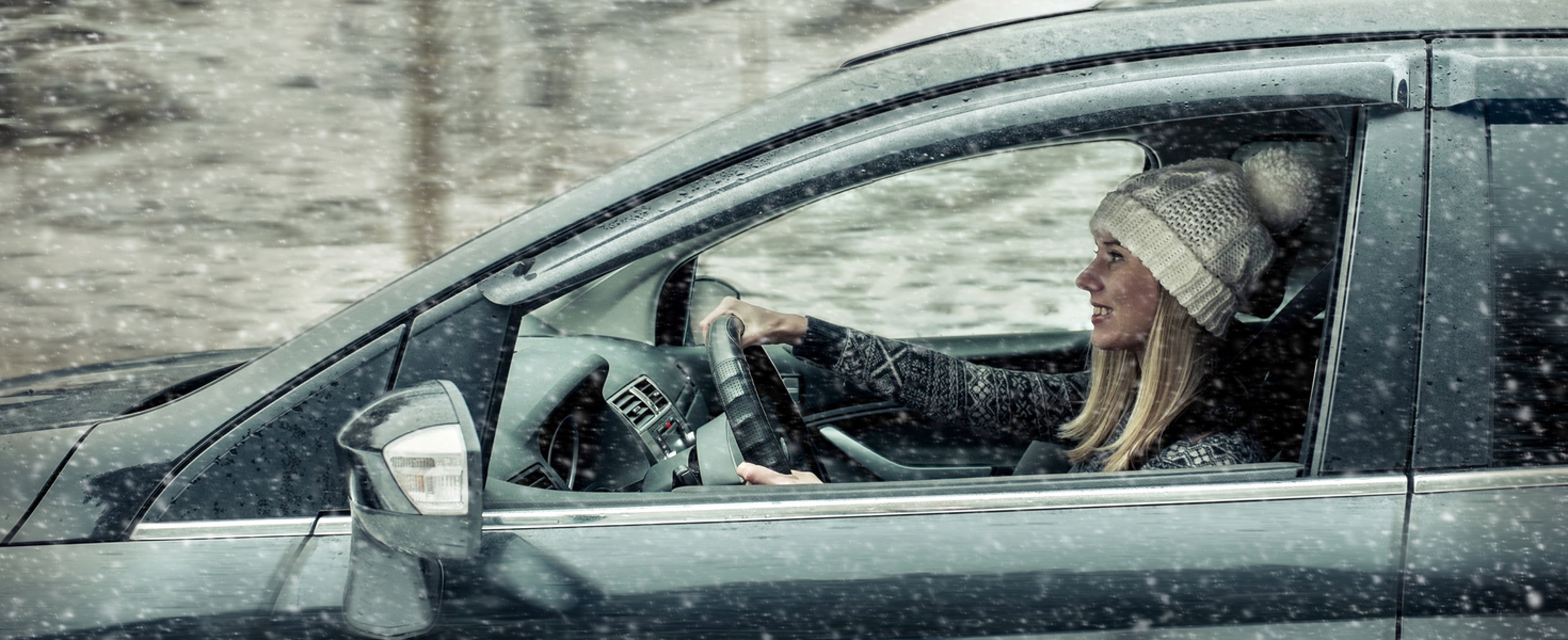 Woman driving in snow 