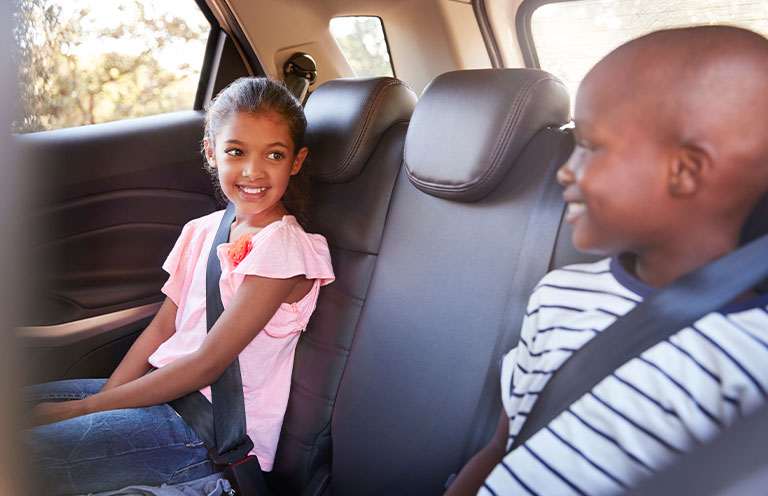 kids wearing seatbelts in backseat