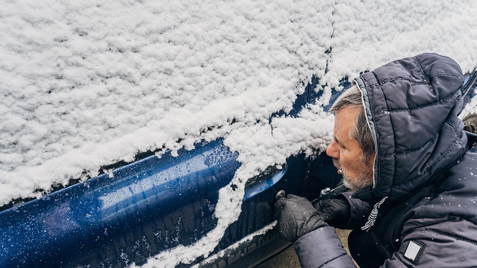 Trying to open car door with snow on it