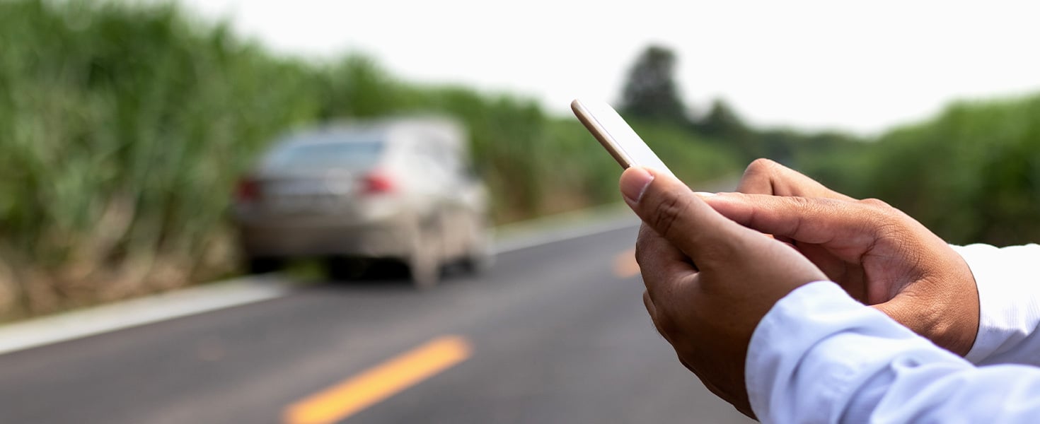 Person on phone looking for roadside assistance