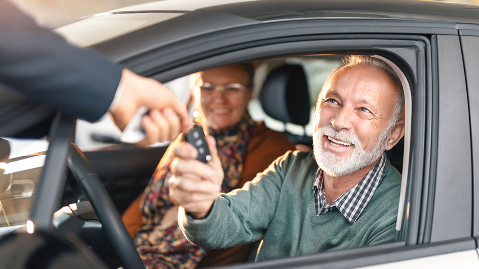 Happy senior couple buying a car