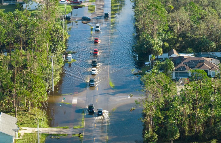 card driving on flooded road