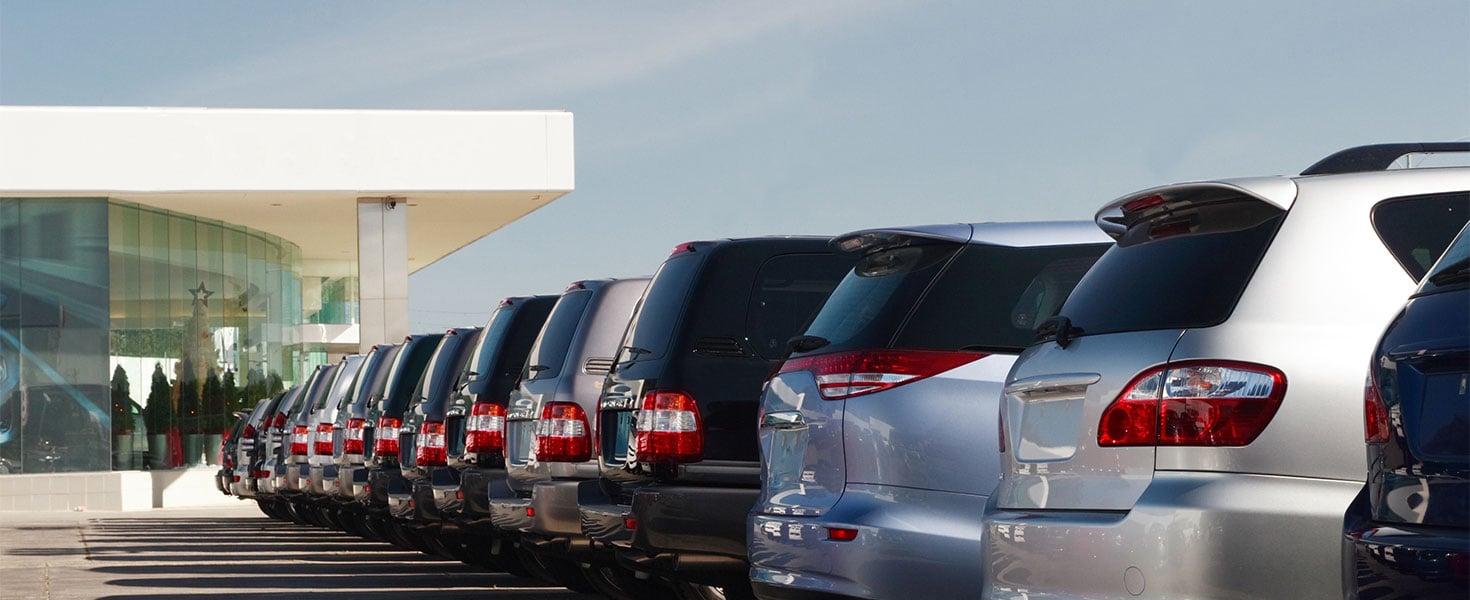 cars in the lot outside car dealership