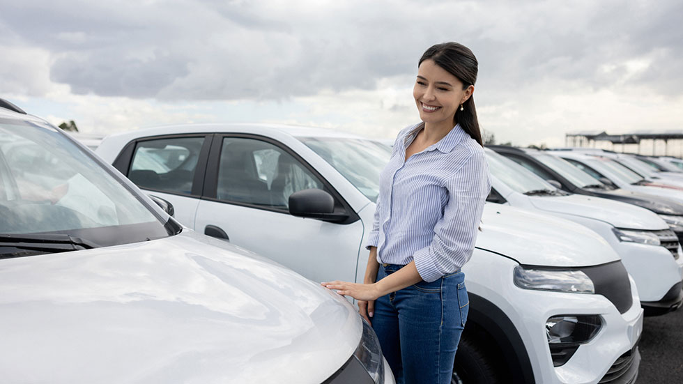 woman looking at a new car