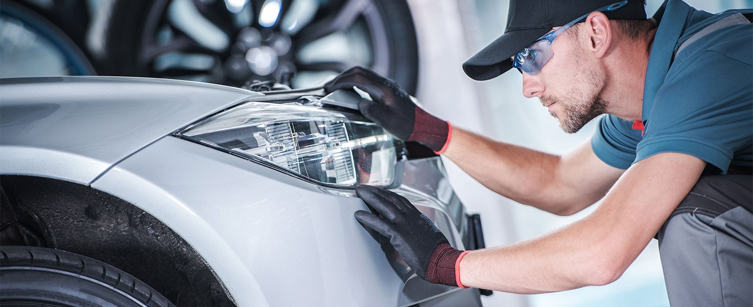 Man adjusting car headlights