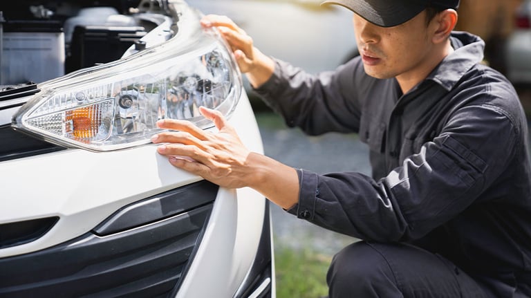 Man adjusting car headlights