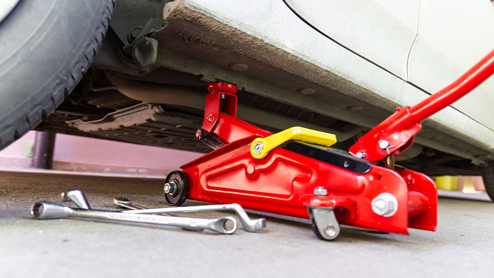 jack placed under frame to change a tire