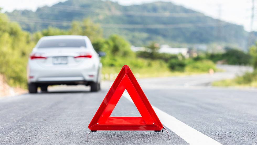 woman using jack while changing tire