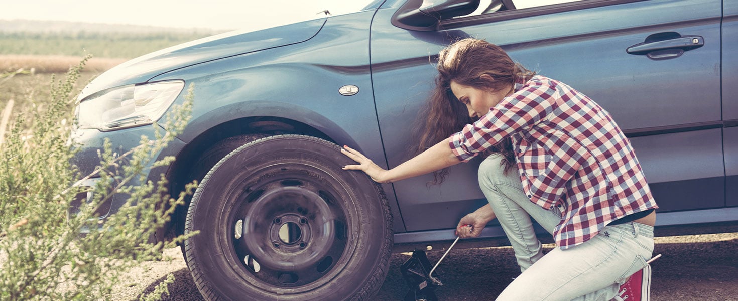 woman changing tire