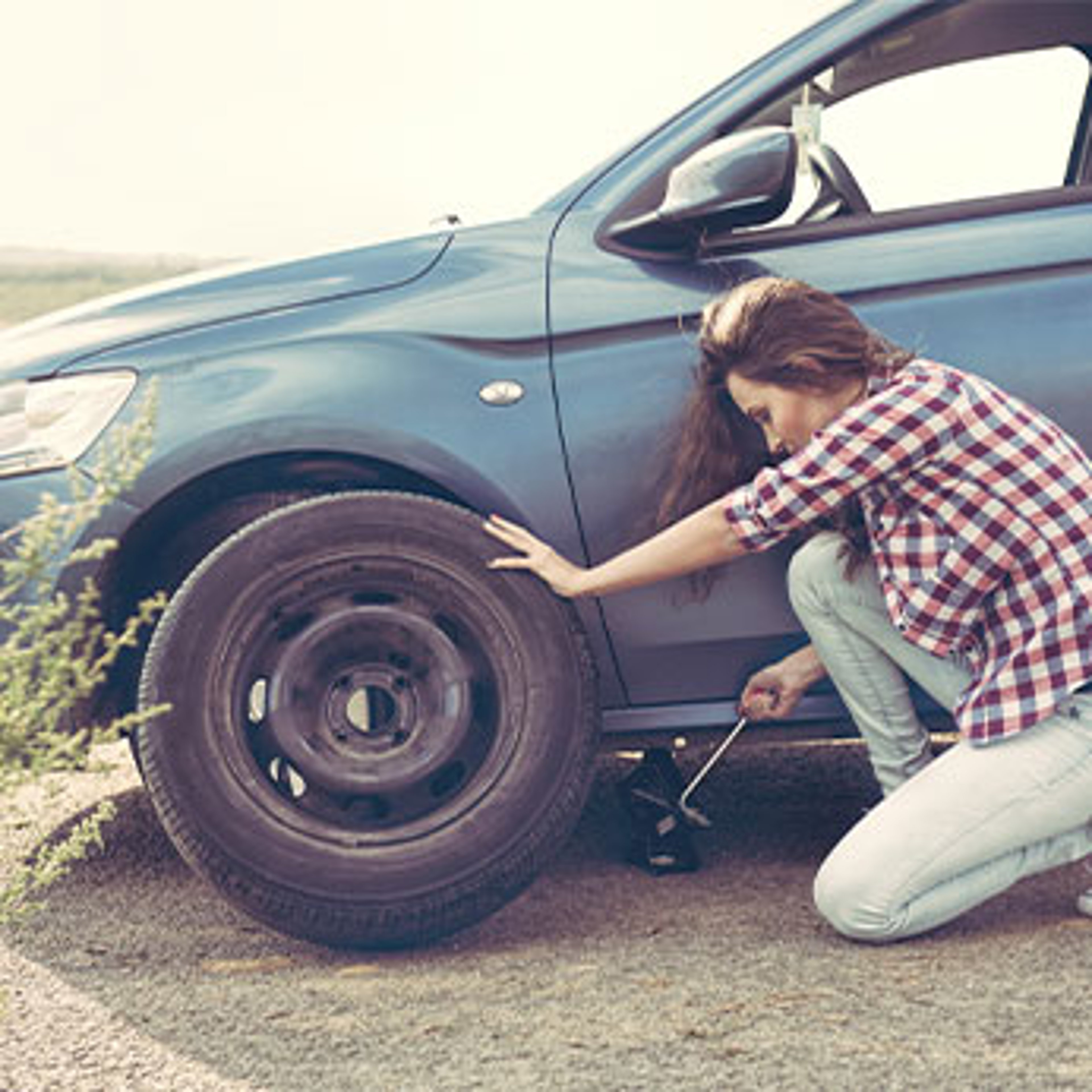 woman changing tire
