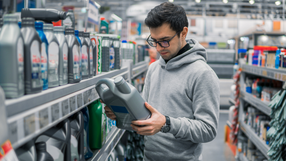 Man looking at motor oil in store