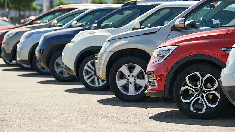 row of used cars. Rental or automobile sale services by Kadmy
