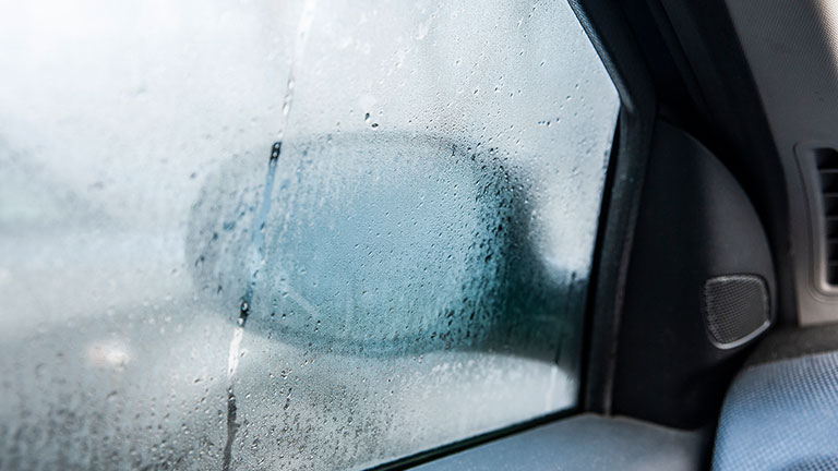 Steamy car window on a autumn rainy/foggy day. Concept of safety driving problem Credit:dies-irae