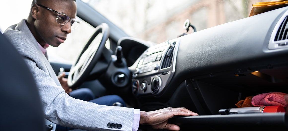 man looking into glove box