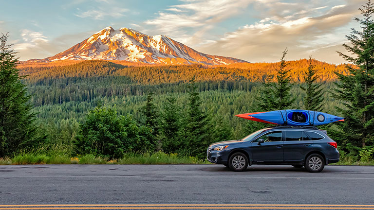 Gifford Pinchot National Forest, Washington - July 13, 2018: SUV with Kayaks in front of Mt. Adams at sunset Credit:Mark Lee