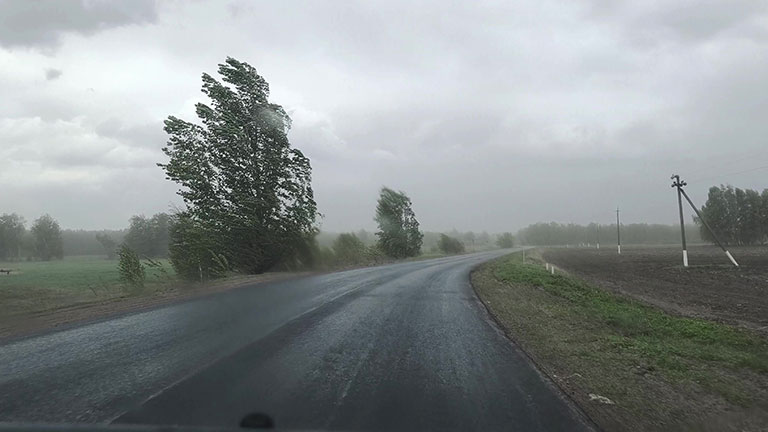 Working as taxi driver in city in bad rainy weather and way to job By Prostock-studio