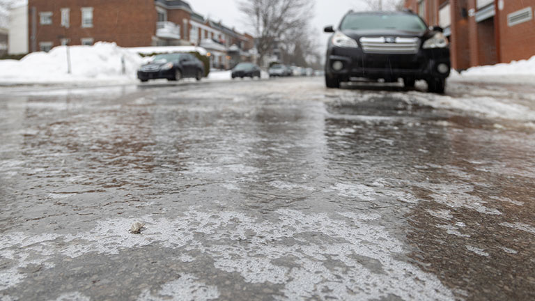 Icy street after ice rain By Nicolas St-Germain