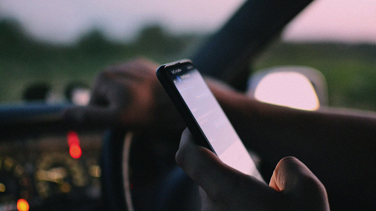 A Person Inside a Car Using a Cellphone Credit: Darya Grey_Owl with Pexels
