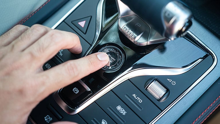 Action of a driver is pressing on the engine start button to starting the car. Close-up and selective focus. Credit:Thank you for your assistant