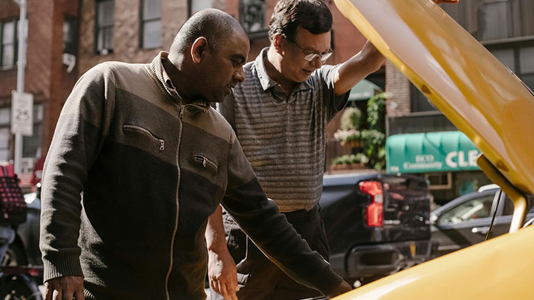Multiethnic men repairing car on street Credit: Tim Samuel with Pexels