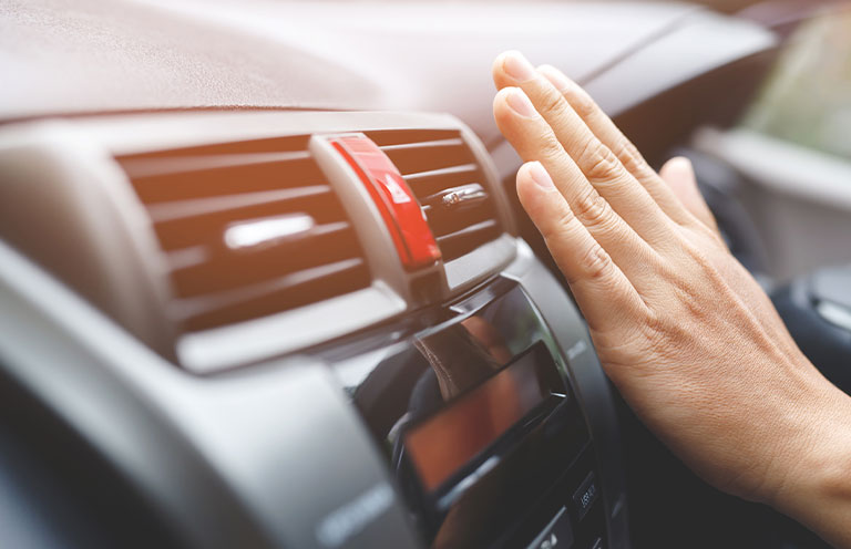 hand over air vents in car