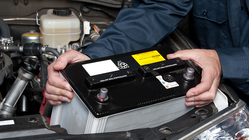 Auto Mechanic Replacing Car Battery