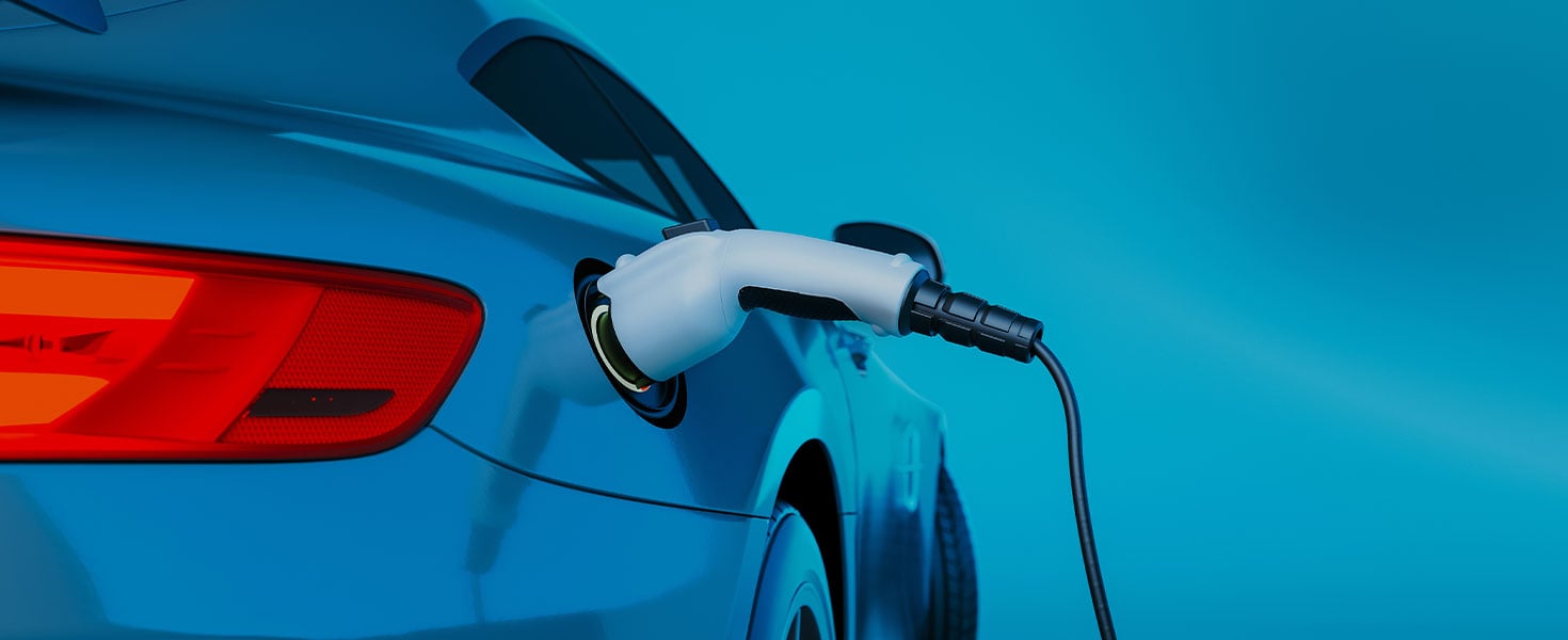 blue electric vehicle being charged