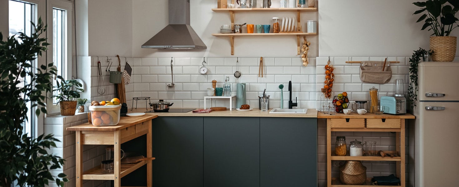 Utensils arranged on shelves and kitchen counter by wooden tables in clean kitchen at home Credit:mixetto
