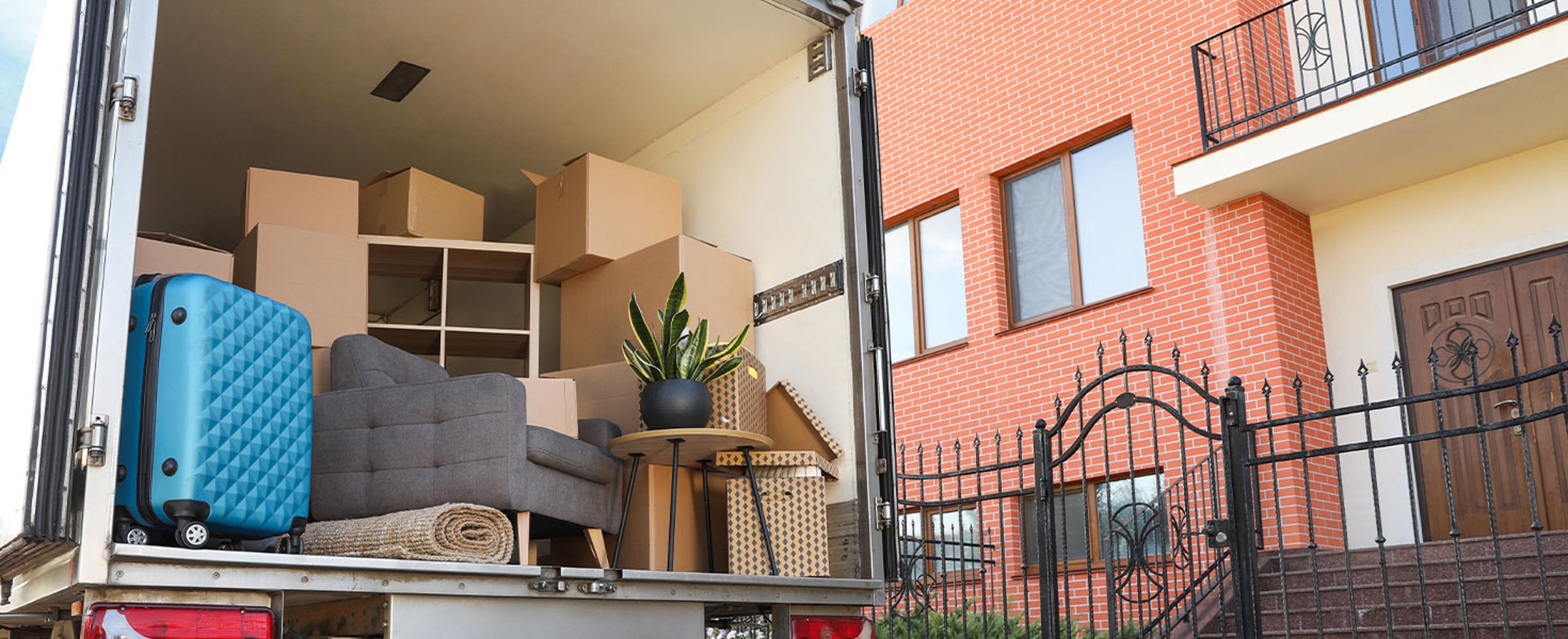 moving truck filled with items outside of home