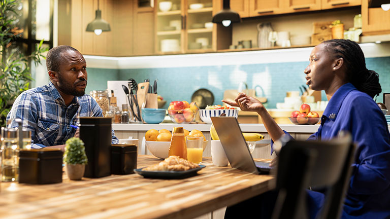 Happy black couple creating a grocery list to compare products and order food Credit: Dragos Condrea
