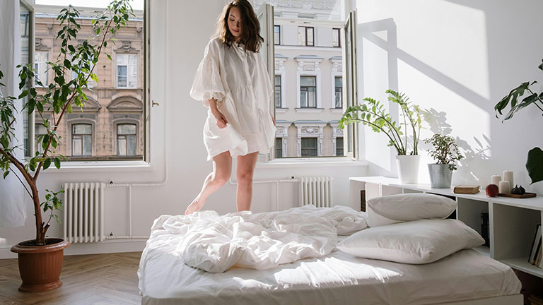 Woman in White Dress Standing on the Bed Credit: cottonbro studio with Pexels