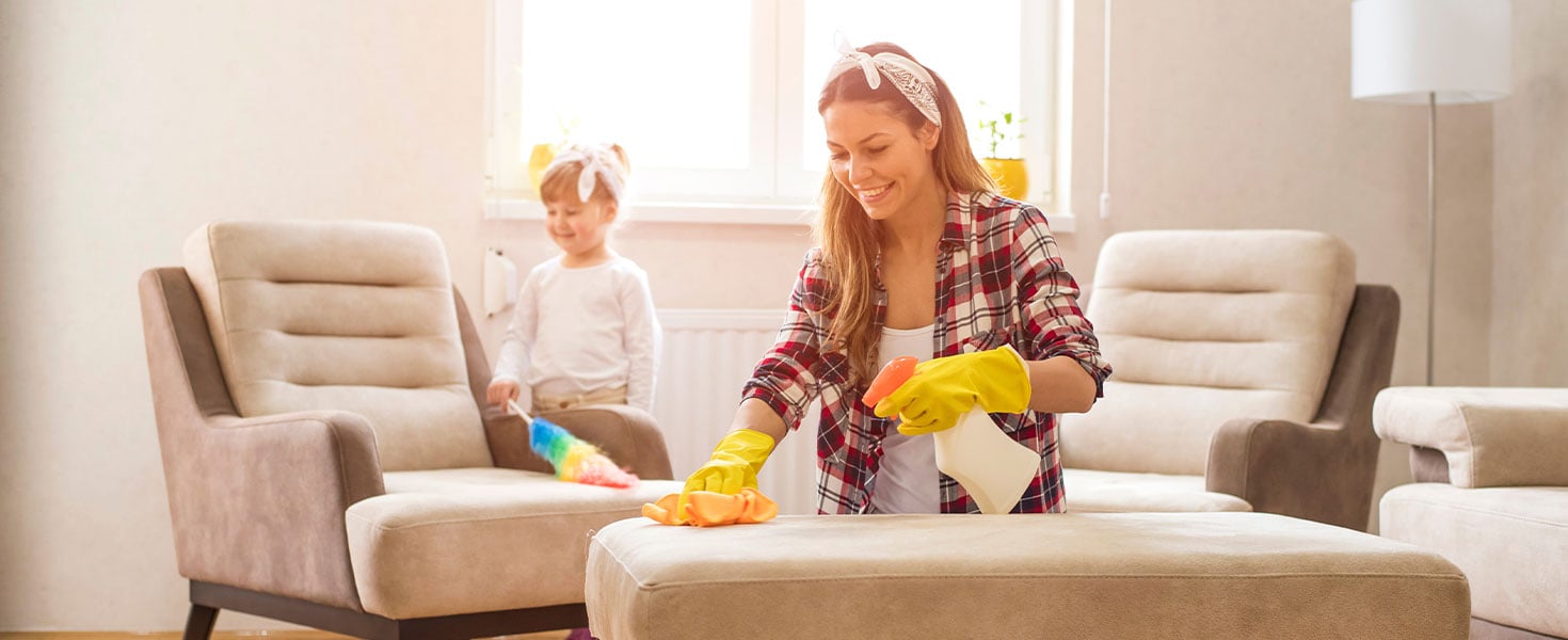 mother and daughter cleaning furniture