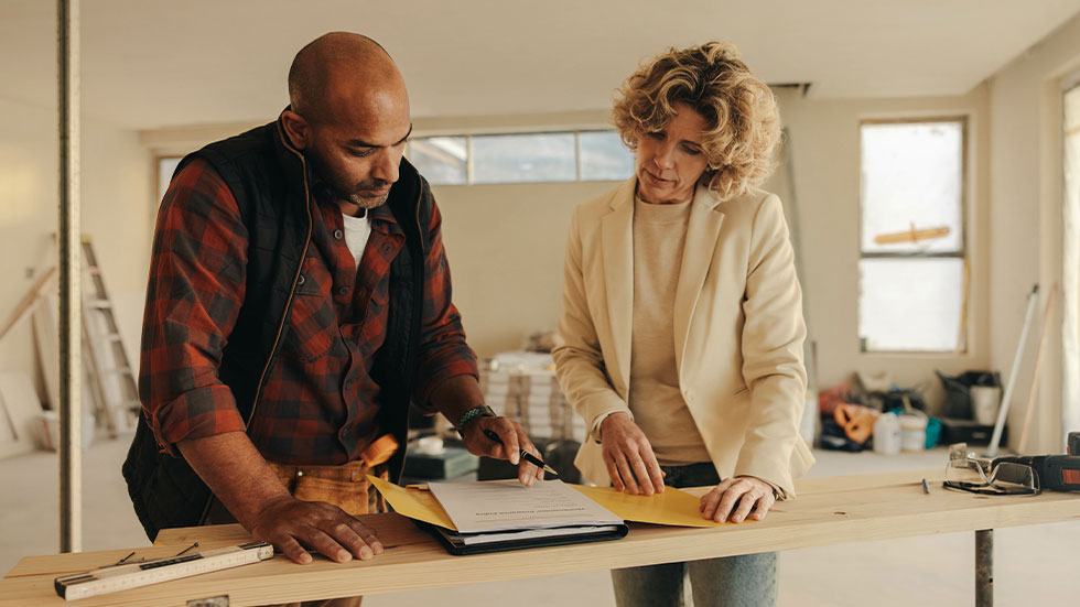 Woman speaking with contractor during home renovation
