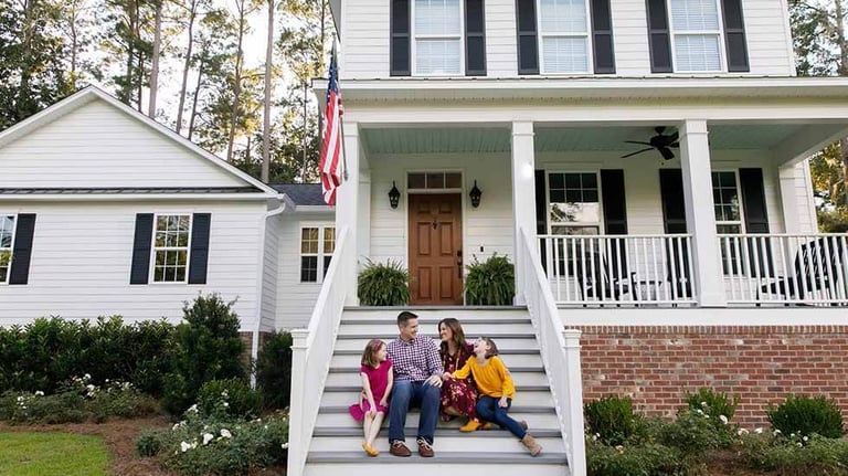 Family in front of house