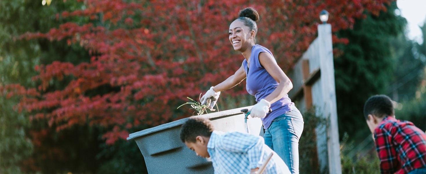 mother and sons cleaning up yard