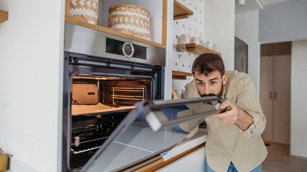 man looking at oven