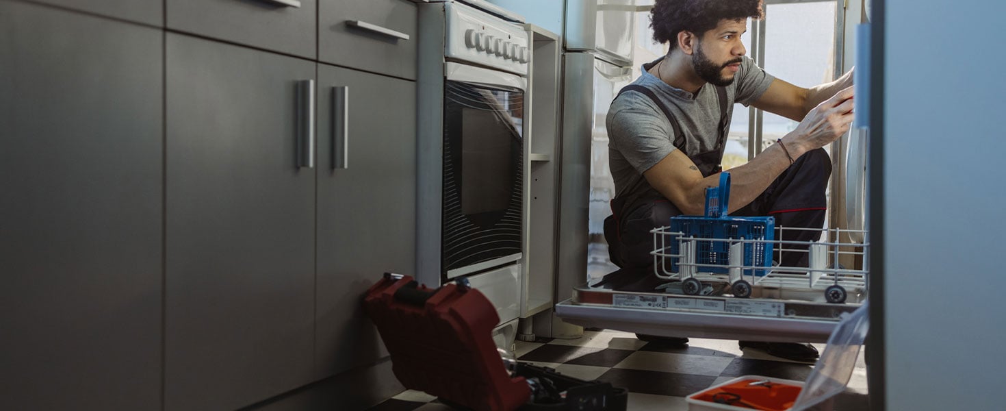 man fixing dishwasher