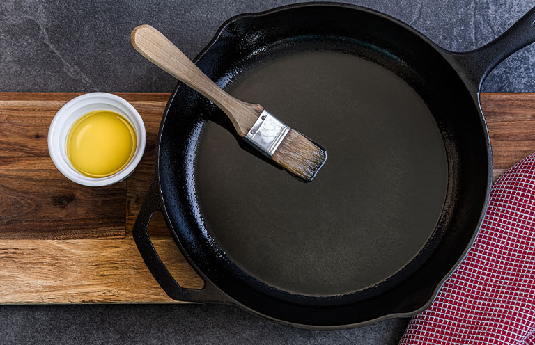 cast iron skillet and olive oil with brush