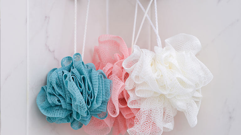Blue, pink and white shower scrubbers by Stepan Popov